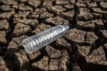 Water Bottles On Dry Soil With Dry And Cracked Soil,global Warming