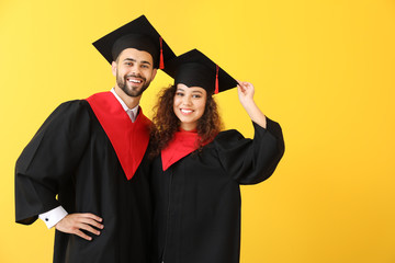 Sticker - Young students in bachelor robes on color background