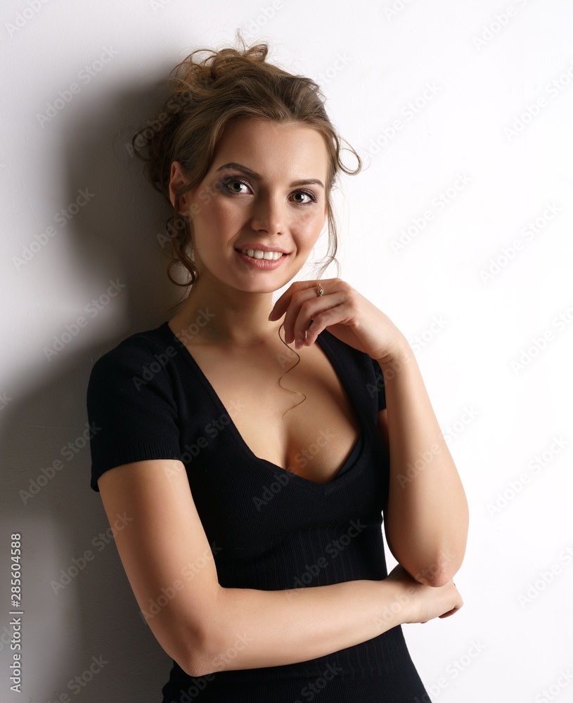 Smiling pretty woman in black skin-tight dress Stock Photo