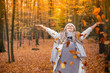 © MrsLePew - Girl walking in the park in autumn and smiles with open arms