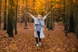 © MrsLePew - Girl walking in the park in autumn and smiles with open arms