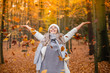 © MrsLePew - Casual young woman enjoying autumn season at forest