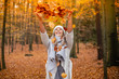 © MrsLePew - Casual young woman enjoying autumn season at forest