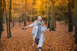 © MrsLePew - Girl walking in the park in autumn and smiles with open arms