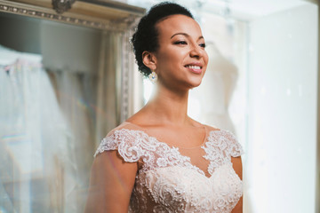 Beautifu bride choosing wedding dress in a wedding salon