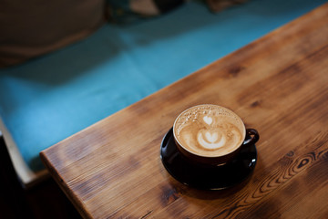 cup of coffee on wooden table