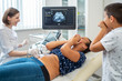 © Nejron Photo - Pregnant woman and her son on utltrasonographic examination at hospital