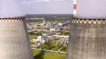 Soaring heat power station, aerial flight nearby. In the summer, shot 4k. Close up.