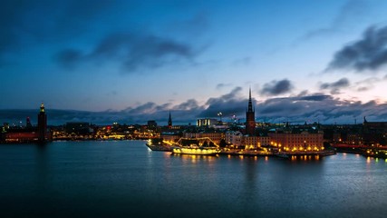 Wall Mural - Stockholm, Sweden. Time-lapse of Gamla Stan in Stockholm, Sweden with landmarks like Riddarholm Church during the sunrise. View of old buildings and cloudy sky in morning