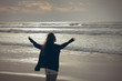 © WavebreakMediaMicro - Woman standing with open arms at beach