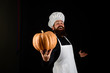 Useful vegetables. Autumn crop. Seasonal vitamin. Happy chef man with beard holds pumpkin. Thanksgiving day cooking. Autumn recipes concept. Bearded man cook in chef hat with pumpkin. Happy halloween.