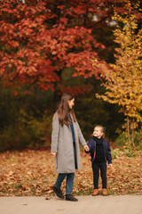 Two sisters walk in the park in autumn time. Childhood. season and people consept-happy family. Portrait of happy sisters in forest