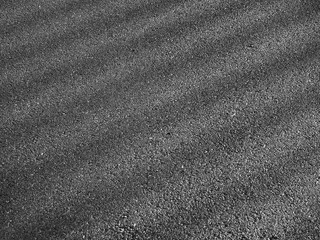 Poster - wet asphalt road with dark shadow of fence and light of morning