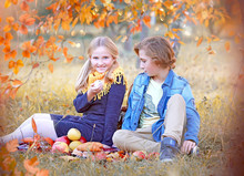 Children In The Autumn Park Walk And Have Fun