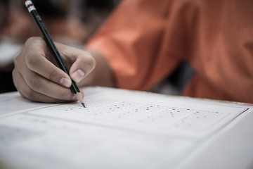 Wall Mural - exam test school or university concept : hand student holding pencil writing standardized answer mul
