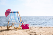Lounger, Hat And Bag On Sand Near Sea, Space For Text. Beach Objects