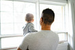 © Louis-Photo - A Father with cute baby son on bed at home