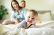 © Louis-Paul Photo - happy family mother, father and son at home in bed