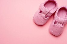 Baby Textile Slippers For Girl On Pink Background With Copy Space.