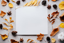 Autumn Composition, Thanksgiving Day Greeting Card. White Mockup Paper Sheet With Faded Floral Decoration On Stone Background. Copy Space.