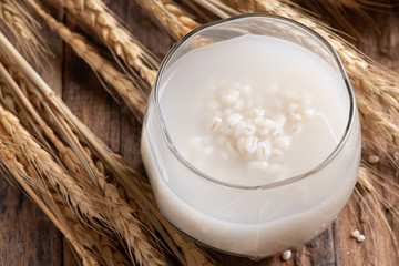 Canvas Print - Barley water in glass with raw and cooked