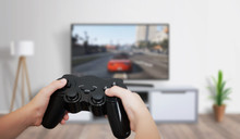 Boy Play Game On Large TV In Living Room. Concept Of Digital Entertainment, Gaming Industry.