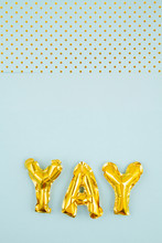 Inflated Letters Yay Ove The Pastel Background With Golden Polka Dots. Party, Celebration, Holidays