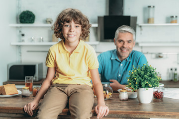 Canvas Print - Kid spending time at kitchen with father