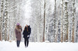 © alexkich - A young girl in a winter park on a walk. Christmas holidays in the winter forest. The girl enjoys winter in the park.
