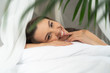 © Yakobchuk Olena - Cute young woman lying in bed and smiling