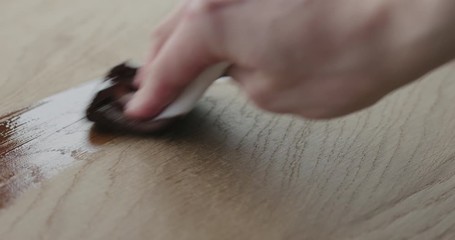 Wall Mural - Slow motion applying oil finish to oak surface with cloth