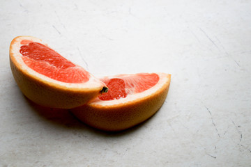 Wall Mural - Sliced grapefruit on a stone table