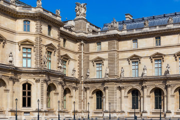 Wall Mural - Details of the facade of the Louvre, Paris, France. Is the world's largest art museum and is housed in the Louvre Palace, originally built in the late 12th to 13th century.