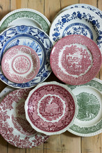 Vintage Porcelain Plates In Different Sizes And Colors On A Wooden Background. Rustic Style.