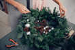 Christmas tree wreath decoration with woman hand workshop DIY