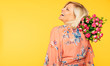 Holiday event. Mother's day. St. Valentines day. Birthday. Portrait of happy cute lovely senior woman in party colorful clothes with large bouquet of flowers on yellow background