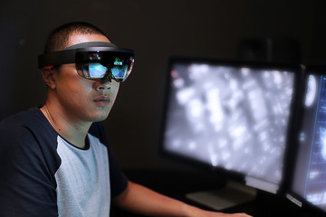 Young men trying Virtual Reality with HoloLens glasses with computer in the laboratory