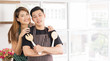 © Supagrit Ninkaesorn - Young Asian couple, Woman have a big smile and embrace his boyfriend from behind in modern kitchen room, Right space for text
