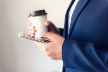 Poster - Business Technology Telecommunication and Communication Network Connection Concept, Close-Up of Businesswoman is Using Mobile Phone for Communicating Information While Holding a Cup of Coffee
