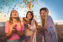 Happy Young People Having Fun At Beach Party, Celebrating With Confetti.