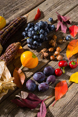 Canvas Print - autumn fruits and vegetables on weathered wooden table background