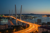 Fototapeta Miasto - Cityscape overlooking the Golden bridge in blue hour. Bright illumination adorns the night city.