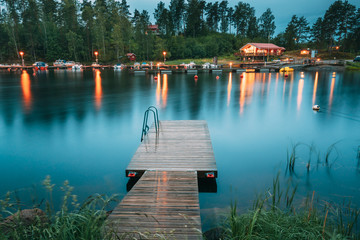 sweden. beautiful wooden pier near lake in summer evening night. lake or river landscape