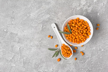 Wall Mural - Fresh ripe sea buckthorn berries in white bowl