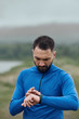 © sata_production - Handsome bearded man checking up his smart watch