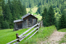 Old Wooden House In The Mountains Against The Background Of The Forest. Summer