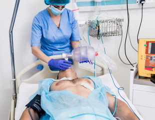 Wall Mural - Doctors give resuscitation to a male patient in the emergency room. Cardiac massage