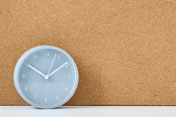 Wall Mural - Gray alarm clock and corc board on a white table