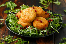 Thai Food Spicy Fish Cakes Served With Pomegranate Seeds And Wild Rocket, Arugula Salad.