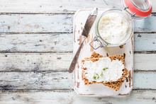 Crispbread Toast With Homemade Herb And Garlic Cottage Cheese On Wooden Background, Top View
